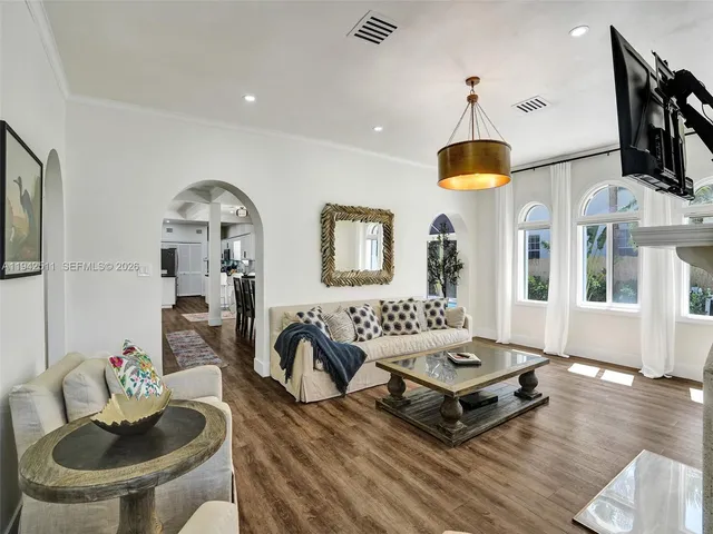 a view of a dining room with furniture and wooden floor