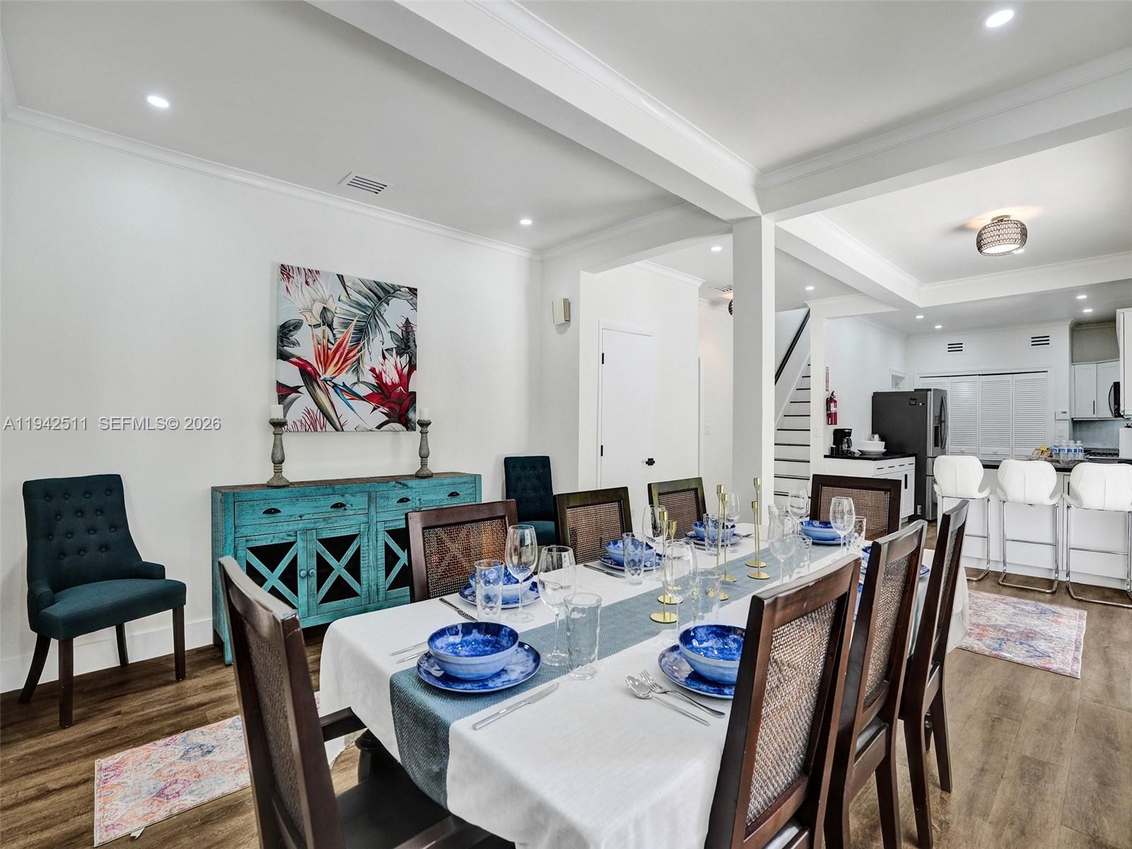 1128 Tyler Street Hollywood, FL 33019 - Photo 8 of 60 a view of a dining room with furniture a chandelier and wooden floor