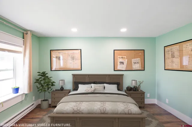 a bedroom with bed and a potted plant
