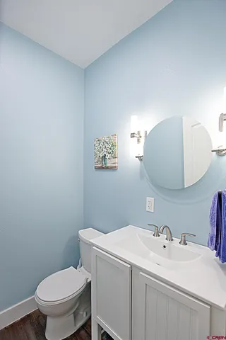 a bathroom with a toilet a sink and mirror