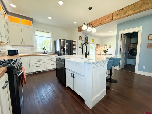 a kitchen with a sink cabinets and wooden floor