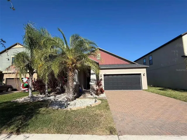 a view of a house with a yard and garage