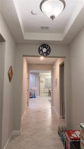 a view of a hallway of a livingroom with a window
