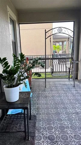 a living room with a couch and a potted plant