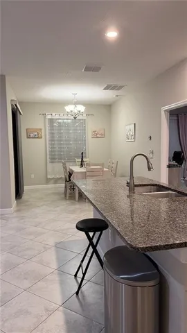 a kitchen with a table chairs and a sink