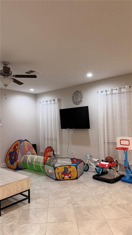 9909 Victory Gallop Loop Ruskin, FL 33573 - Photo 6 of 18 a room with a bed and a couch