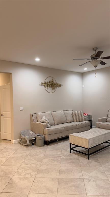 9909 Victory Gallop Loop Ruskin, FL 33573 - Photo 7 of 18 a living room with furniture and a ceiling fan