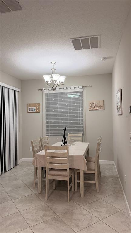 9909 Victory Gallop Loop Ruskin, FL 33573 - Photo 8 of 18 a view of a dining room with furniture