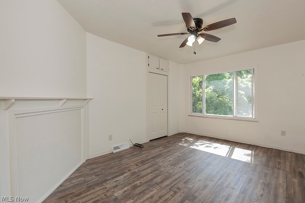3090 Warren Road Cleveland, OH 44111 - Photo 24 of 50 Unfurnished living room featuring dark wood-type flooring and ceiling fan