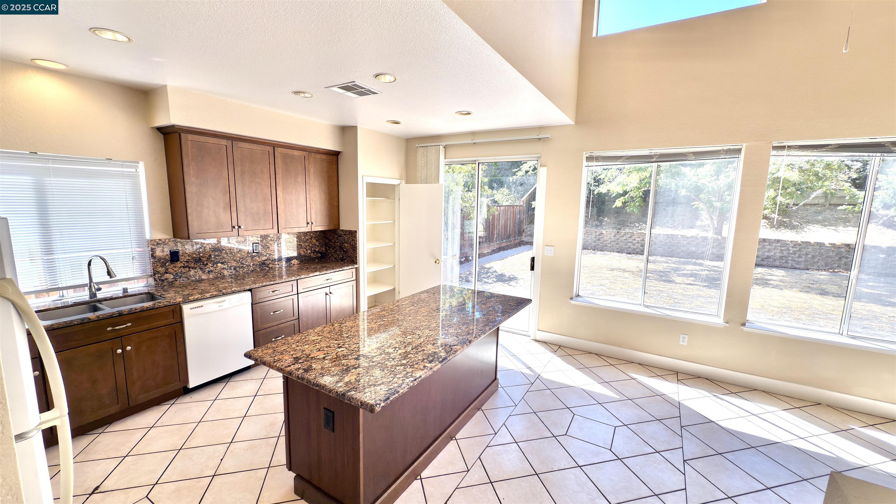 1135 Ranch Point Way Antioch, CA 94531 - Photo 1 of 1 a large kitchen with kitchen island granite countertop a large counter top and appliances