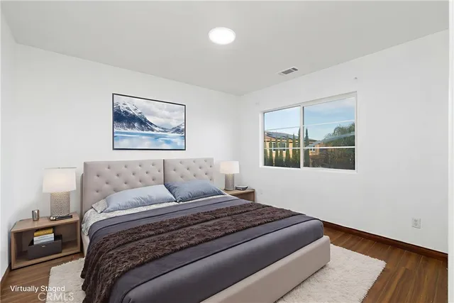 a bedroom with a bed and a painting on the wall