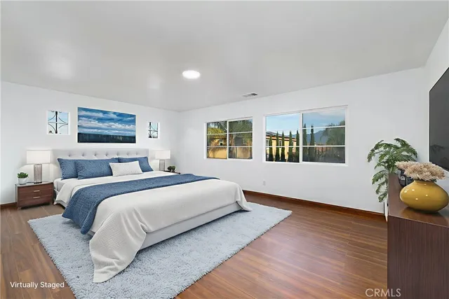 a spacious bedroom with a large bed and a window