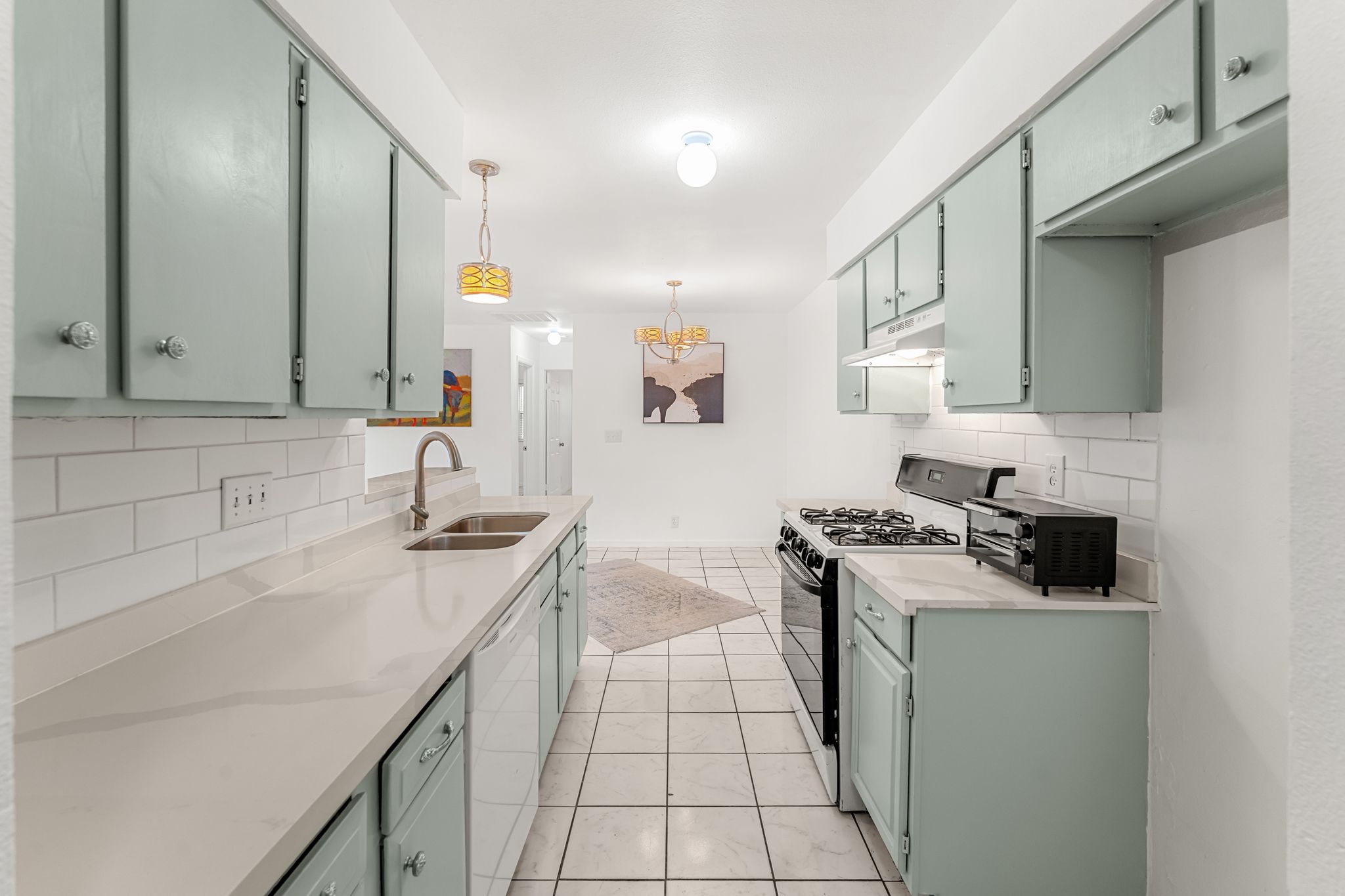 a kitchen with a sink stove top oven and cabinets