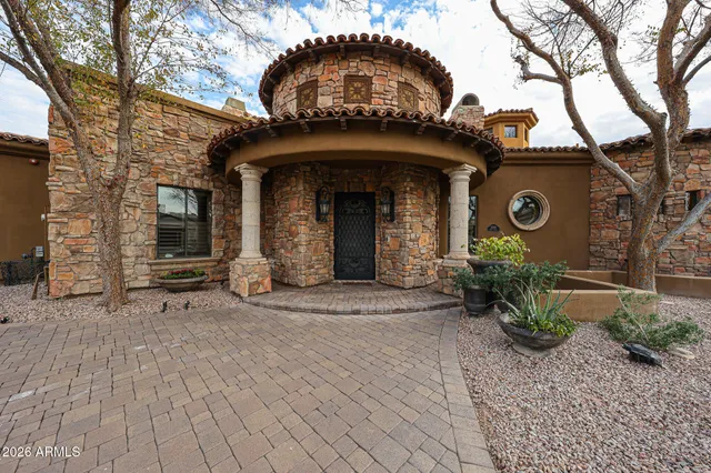 a kitchen with stainless steel appliances granite countertop a stove top oven a sink and a refrigerator