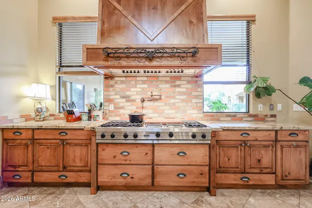 a spacious bedroom with a bed and a flat screen tv