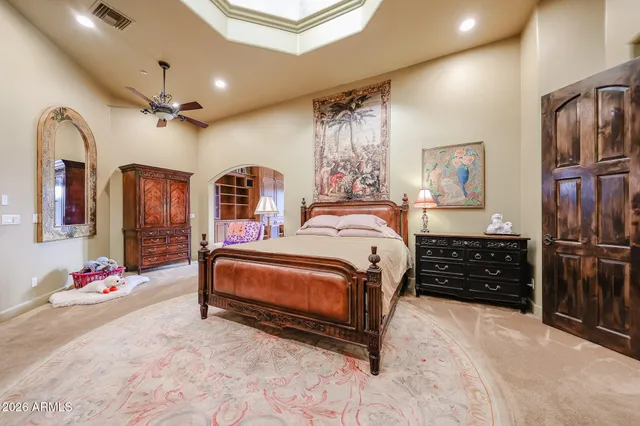 a spacious bathroom with a granite countertop toilet sink and mirror