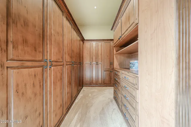 a spacious bedroom with a bed and a chandelier