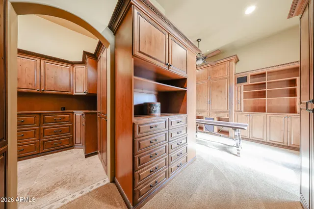 a spacious bedroom with a bed and a chandelier