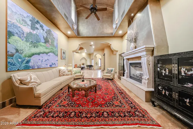 a living room with furniture fireplace and rug