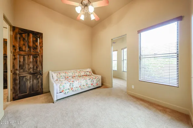a bed sitting in a bedroom next to a window