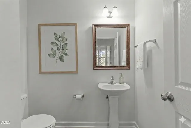 an empty room with wooden floor and fan