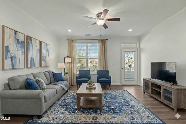 a living room with furniture and a flat screen tv
