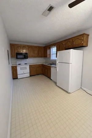 a kitchen with stainless steel appliances a refrigerator and a stove