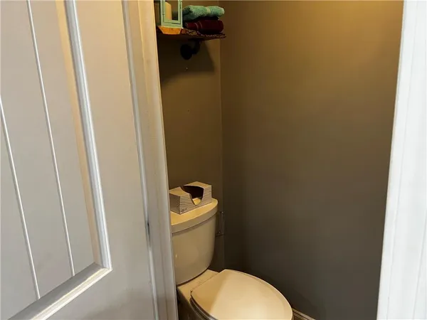 a white toilet sitting next to a small sink