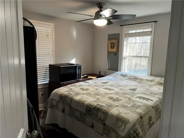 a bedroom with a bed and a chandelier
