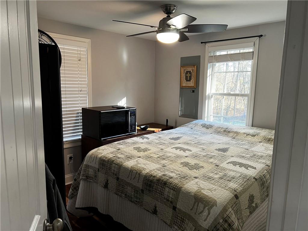 322 Goat Road Northwest Resaca, GA 30735 - Photo 12 of 16 a bedroom with a bed and a chandelier