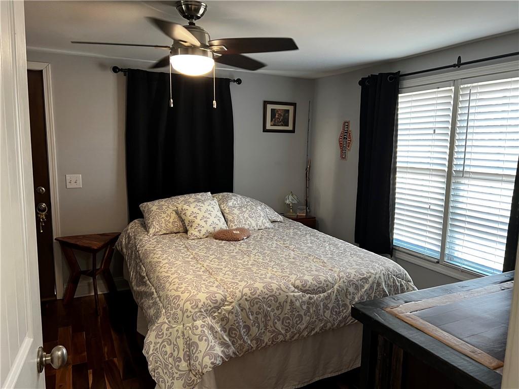 322 Goat Road Northwest Resaca, GA 30735 - Photo 13 of 16 a bedroom with a bed and a chandelier