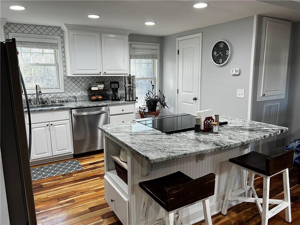 322 Goat Road Northwest Resaca, GA 30735 - Photo 7 of 16 a kitchen with stainless steel appliances granite countertop a stove a sink and a refrigerator