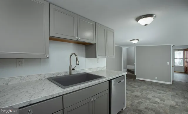 an empty room with closet and windows