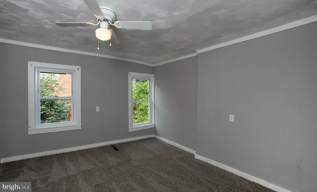 a bathroom with a toilet sink and a mirror
