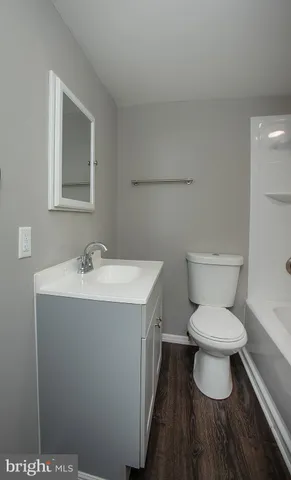 a white toilet sitting next to a bathroom sink