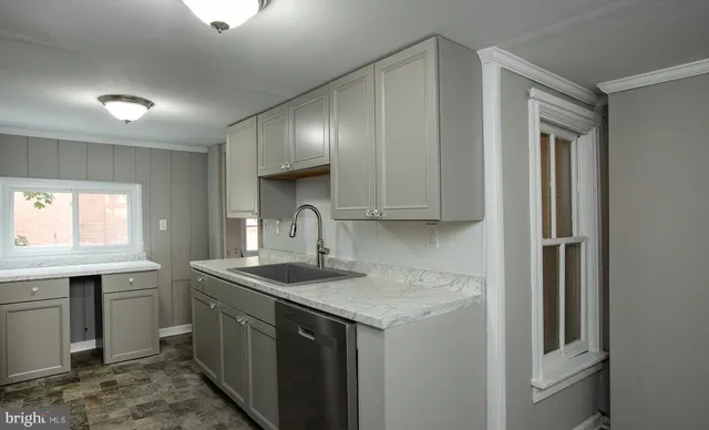 a kitchen with a sink and cabinets