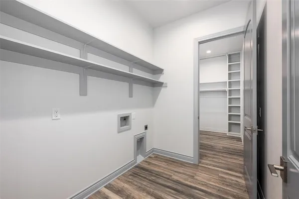 a view of a hallway with wooden floor and closet