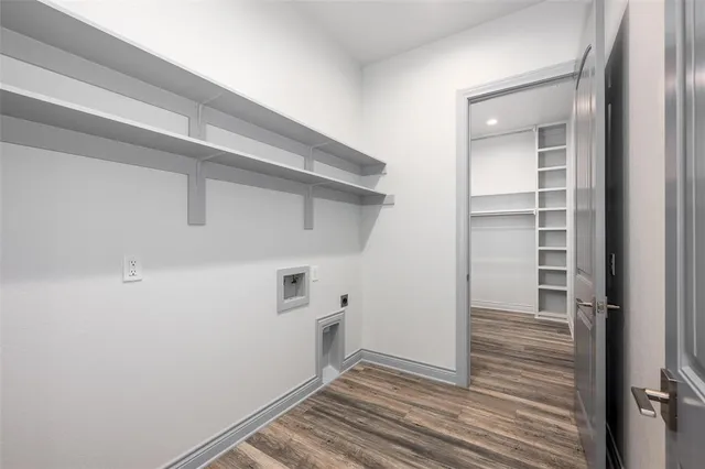 a view of a hallway with wooden floor and closet