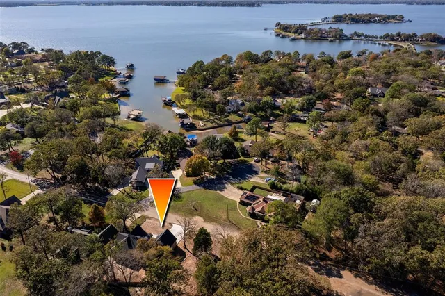 an aerial view of residential house with outdoor space and trees all around