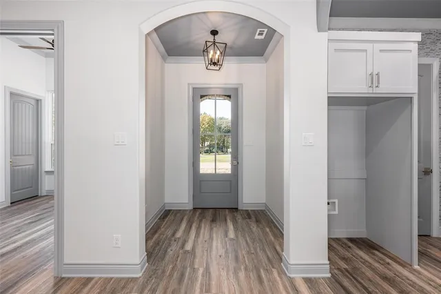 a view of a hallway view with wooden floor and staircase
