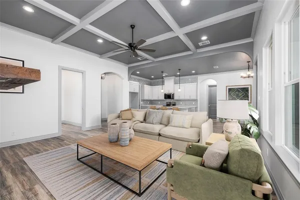 a living room with furniture and a chandelier