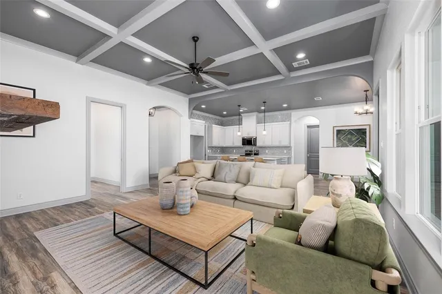 a living room with furniture and a chandelier