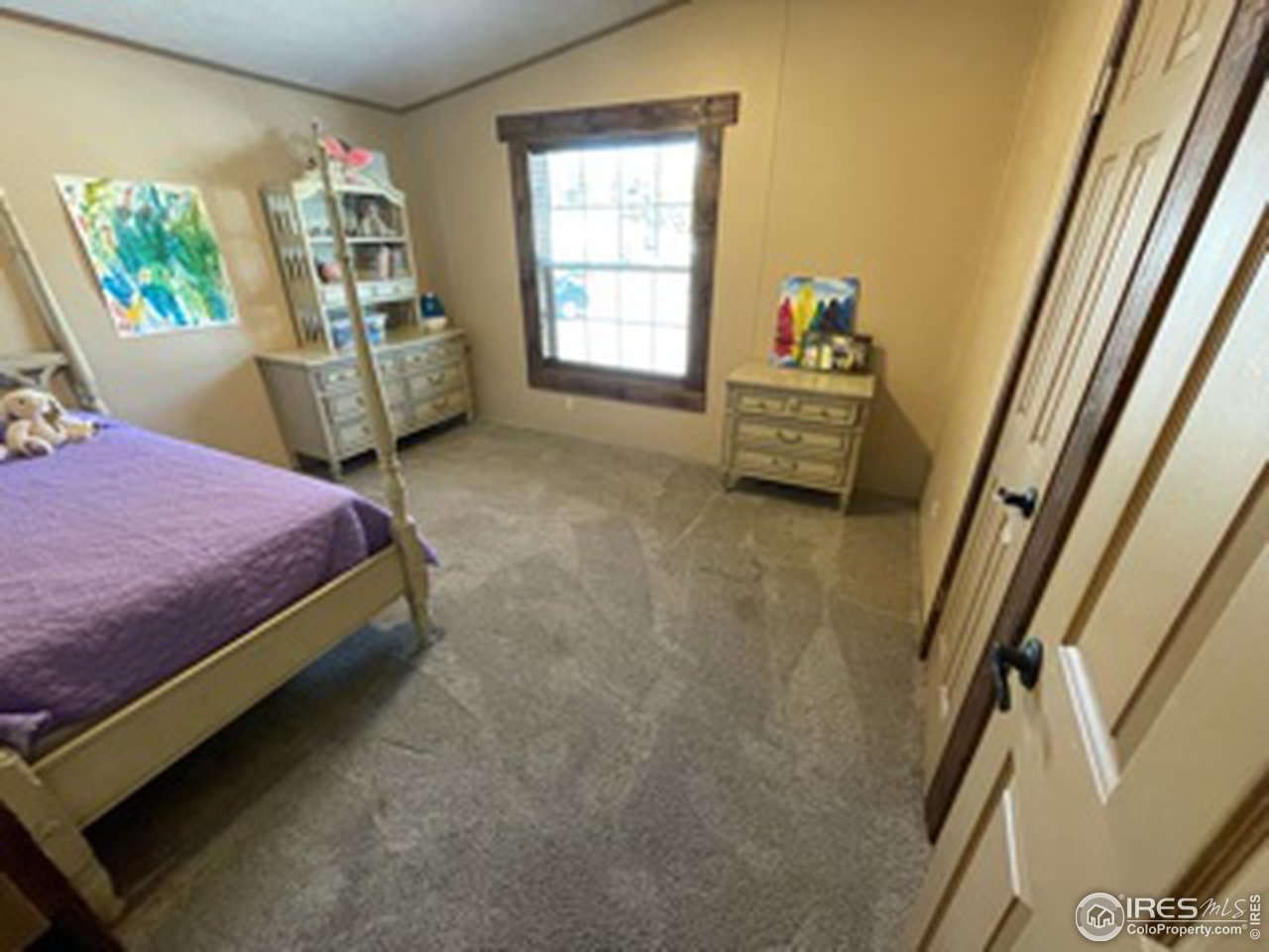 2500 East Harmony Road, Unit 62 Fort Collins, CO 80528 - Photo 12 of 13 a bedroom with a bed next to a window