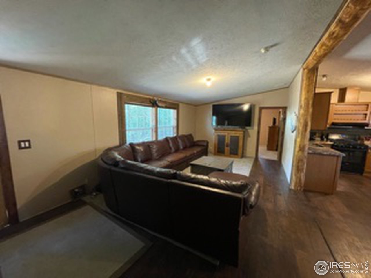 2500 East Harmony Road, Unit 62 Fort Collins, CO 80528 - Photo 2 of 13 a living room with a couch and a stove