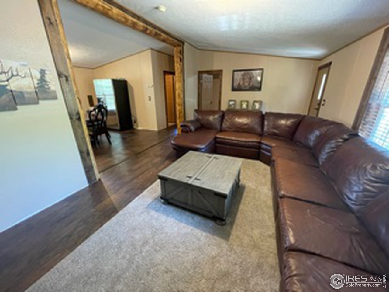 2500 East Harmony Road, Unit 62 Fort Collins, CO 80528 - Photo 3 of 13 a living room with furniture and a wooden floor