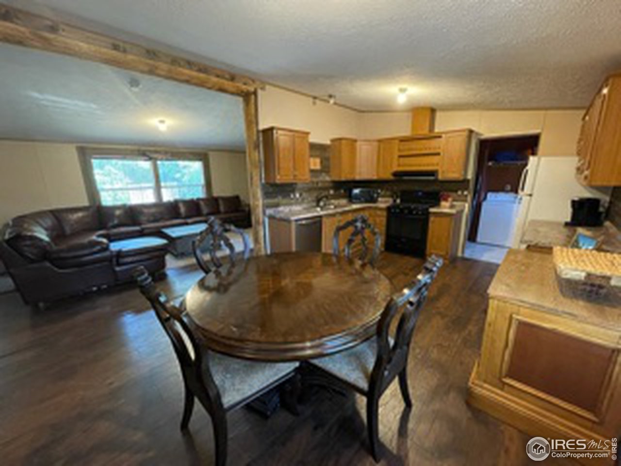 2500 East Harmony Road, Unit 62 Fort Collins, CO 80528 - Photo 6 of 13 a living room with lots of furniture and kitchen view