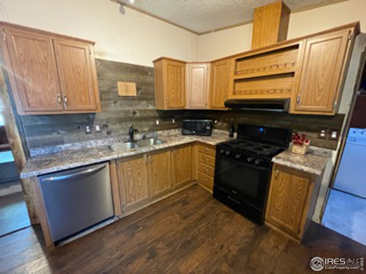 2500 East Harmony Road, Unit 62 Fort Collins, CO 80528 - Photo 7 of 13 a kitchen with a sink stove top oven and cabinets