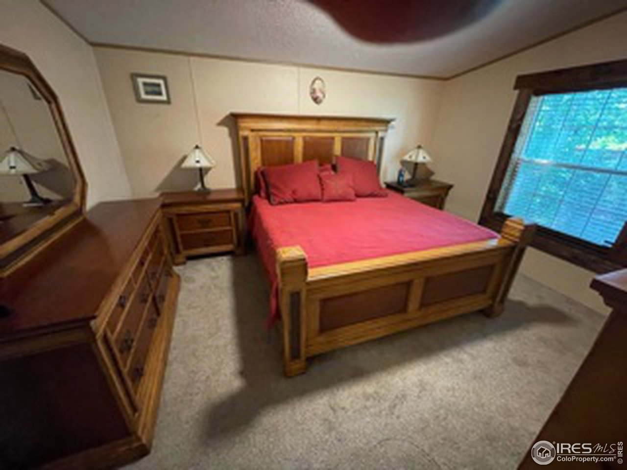 2500 East Harmony Road, Unit 62 Fort Collins, CO 80528 - Photo 8 of 13 a bed sitting in a room next to a window