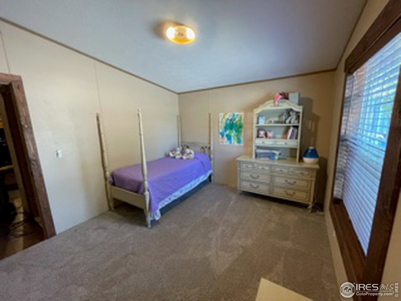 2500 East Harmony Road, Unit 62 Fort Collins, CO 80528 - Photo 10 of 13 a bedroom with a bed and a window