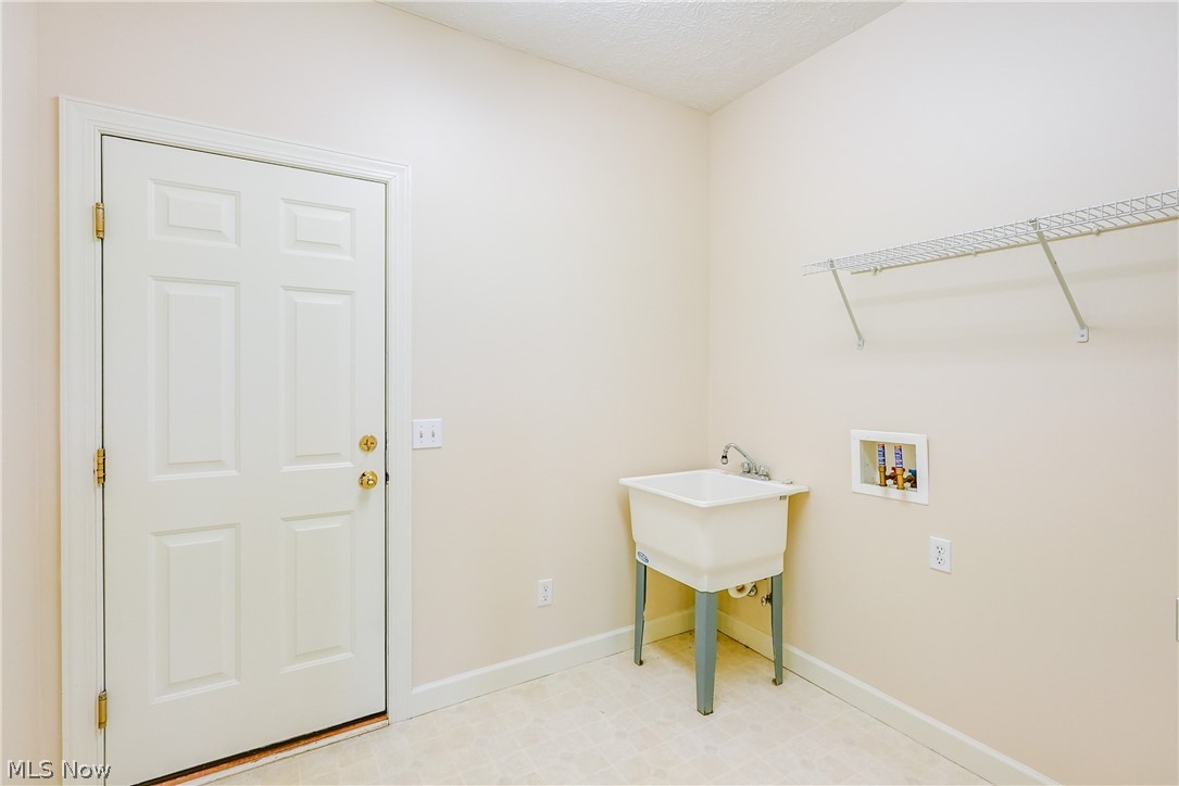 4561 Ridgestone Way Medina, OH 44256 - Photo 22 of 50 Laundry room on main level with handy wash tub, washer hookup and light linoleum flooring. Easy access to the garage.